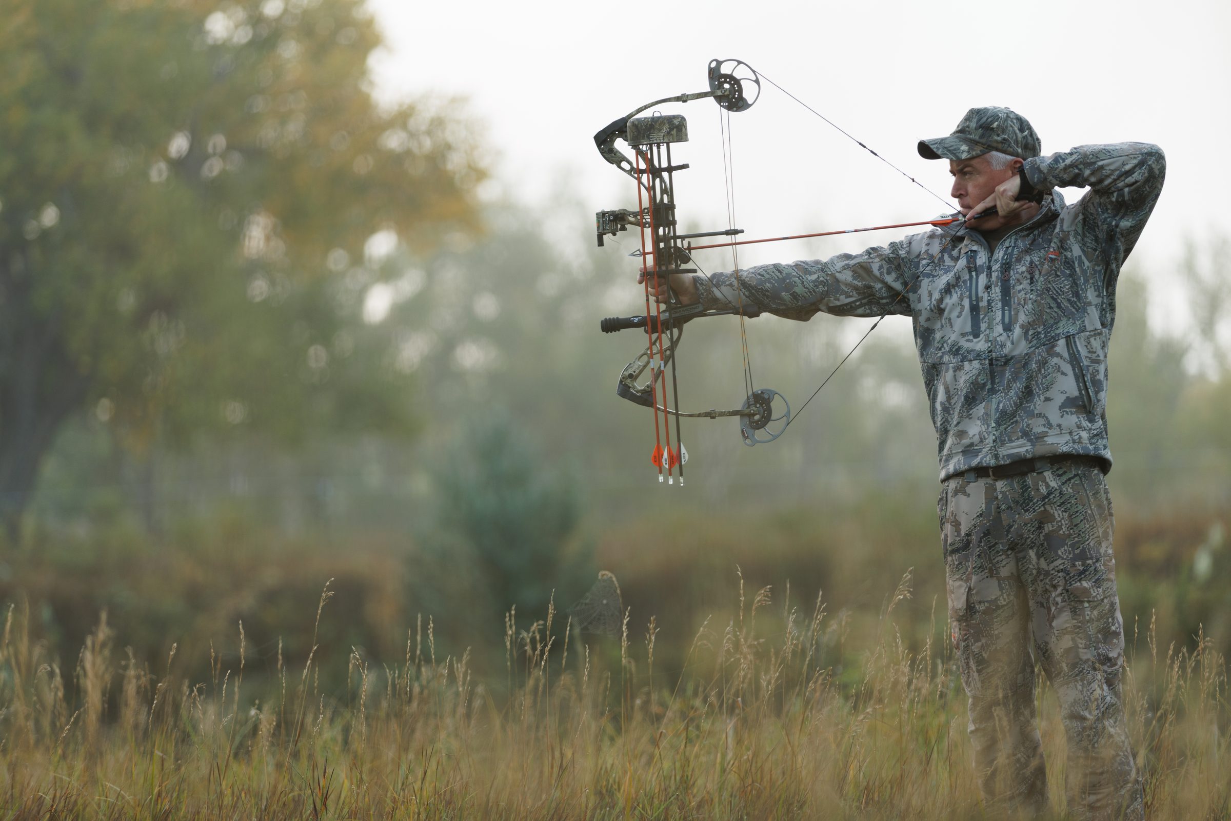 Marty Jackley drawing his bow in a misty field